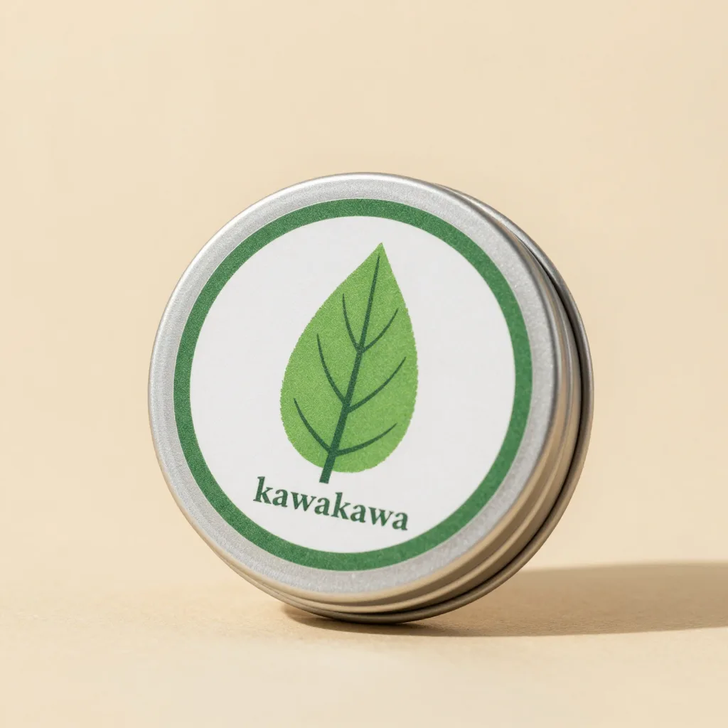 A tin of kawakawa balm with a green leaf label